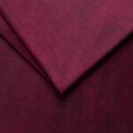 Close-up of red velvet fabric for furniture upholstery.